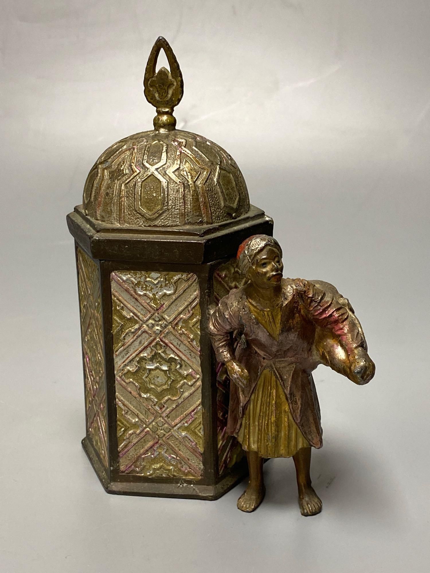 A Bergman style cold painted metal hexagonal casket, with hinged cover, Itinerant labourer alongside, 15cm